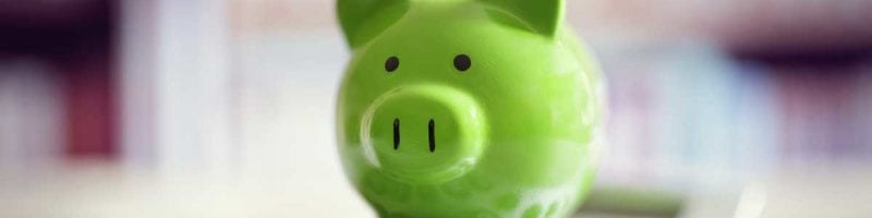 green piggy bank and calculator