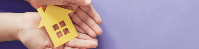 hands holding paper house
