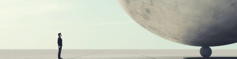 large sphere balanced on another