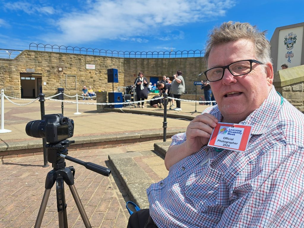 Stephen, who has a learning disability, posing for a picture during Learning Disability Week 2024.