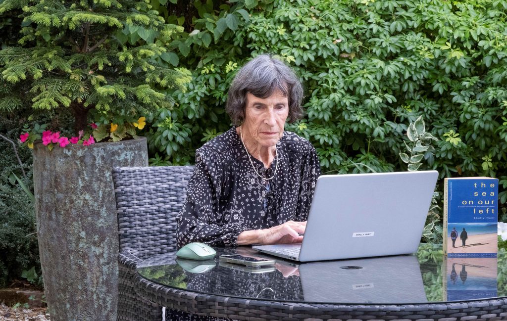 Shally Hunt, an author living in a care home, using her laptop to continue writing her autobiography.