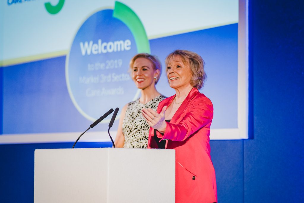 Dame Esther Rantzen and her daughter, Rebecca Wilcox, standing at a lectern.